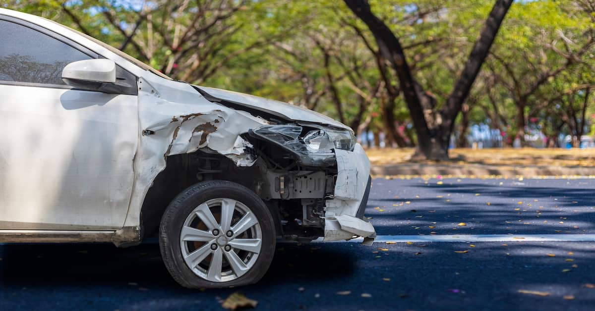Car damaged in a car accident in a parking lot | Colombo Law