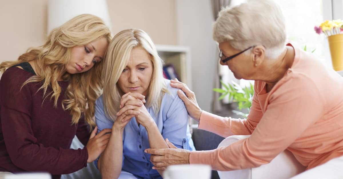 Grief-stricken family members comforting each other after the death of a loved one | Colombo Law